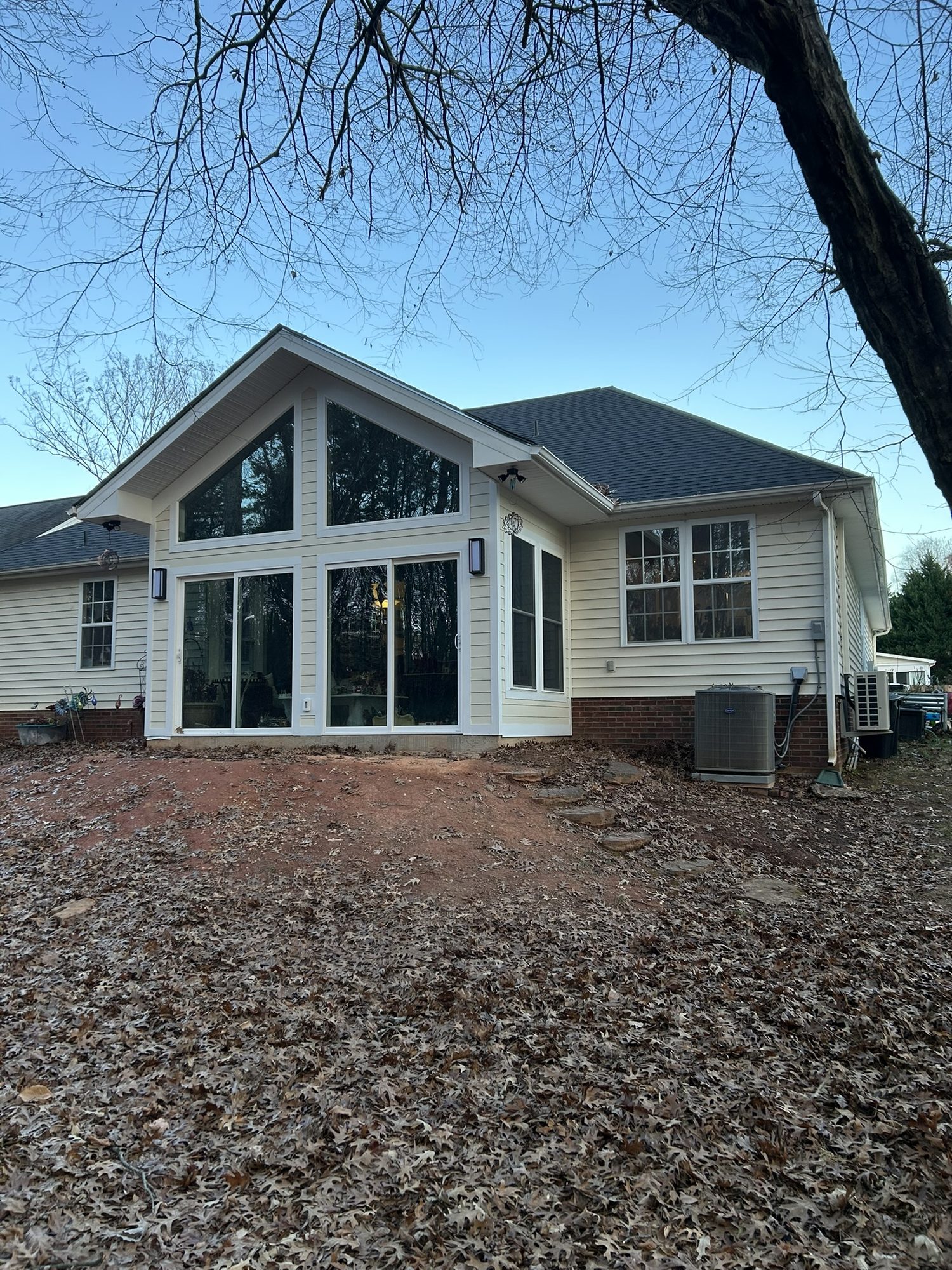 Sunroom addition with a gable wall of windows