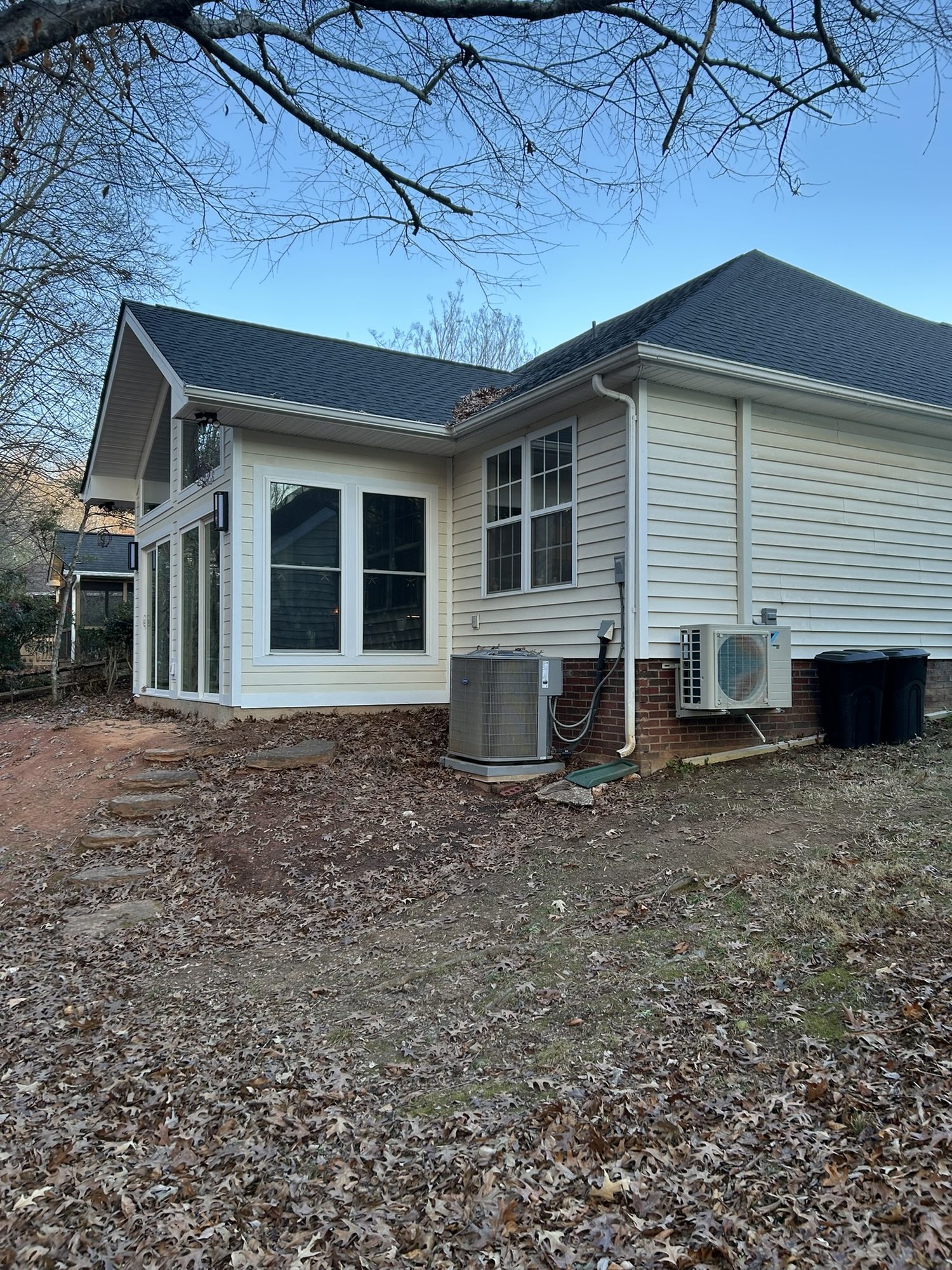 Side view of a sunroom addition with windows and doors